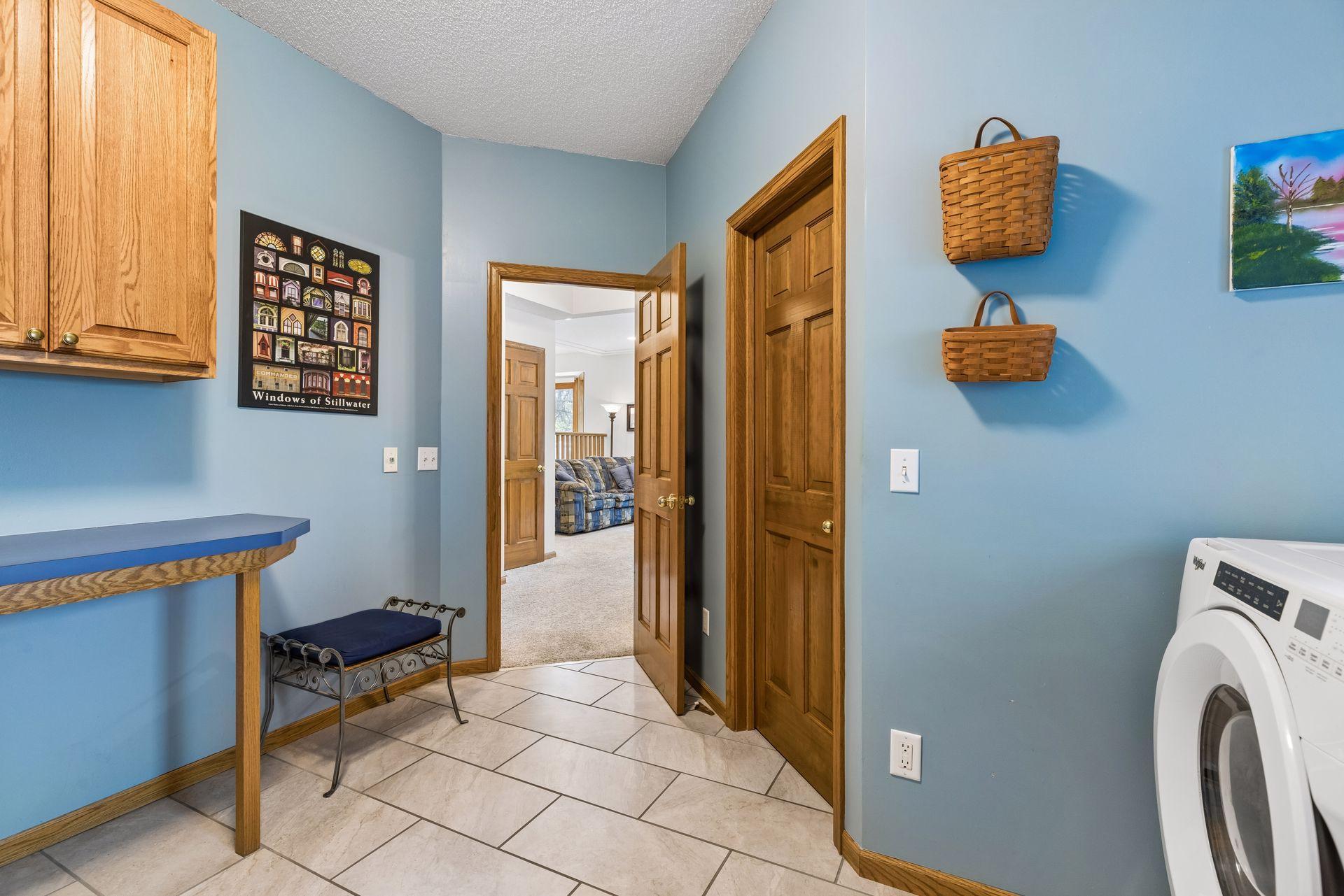 Laundry room with additional storage closet.