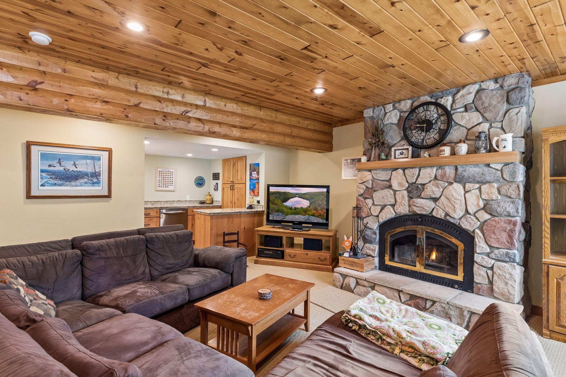 Cozy lower level with fireplace and wet bar/kitchenette—perfect for entertaining.