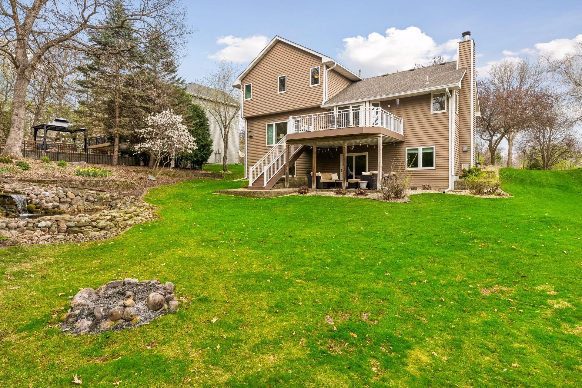 Expansive backyard with multiple outdoor entertaining spaces.