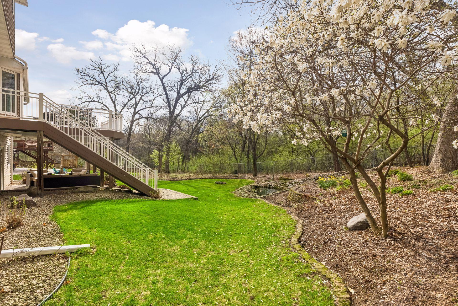 Beautiful landscaping paired with open green space.
