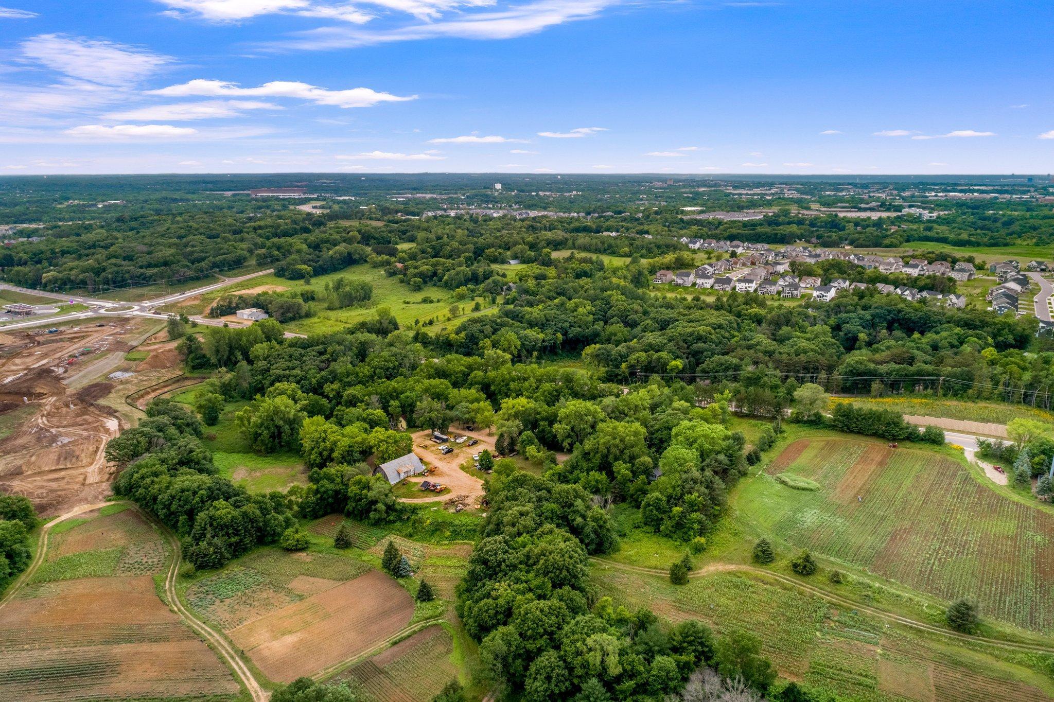 Aerial view from the parcel's northeast corner. Visible barn area is 6680 So. Robert Trail. 6570 So. Robert Trail is due north of the barn area hidden in the trees.