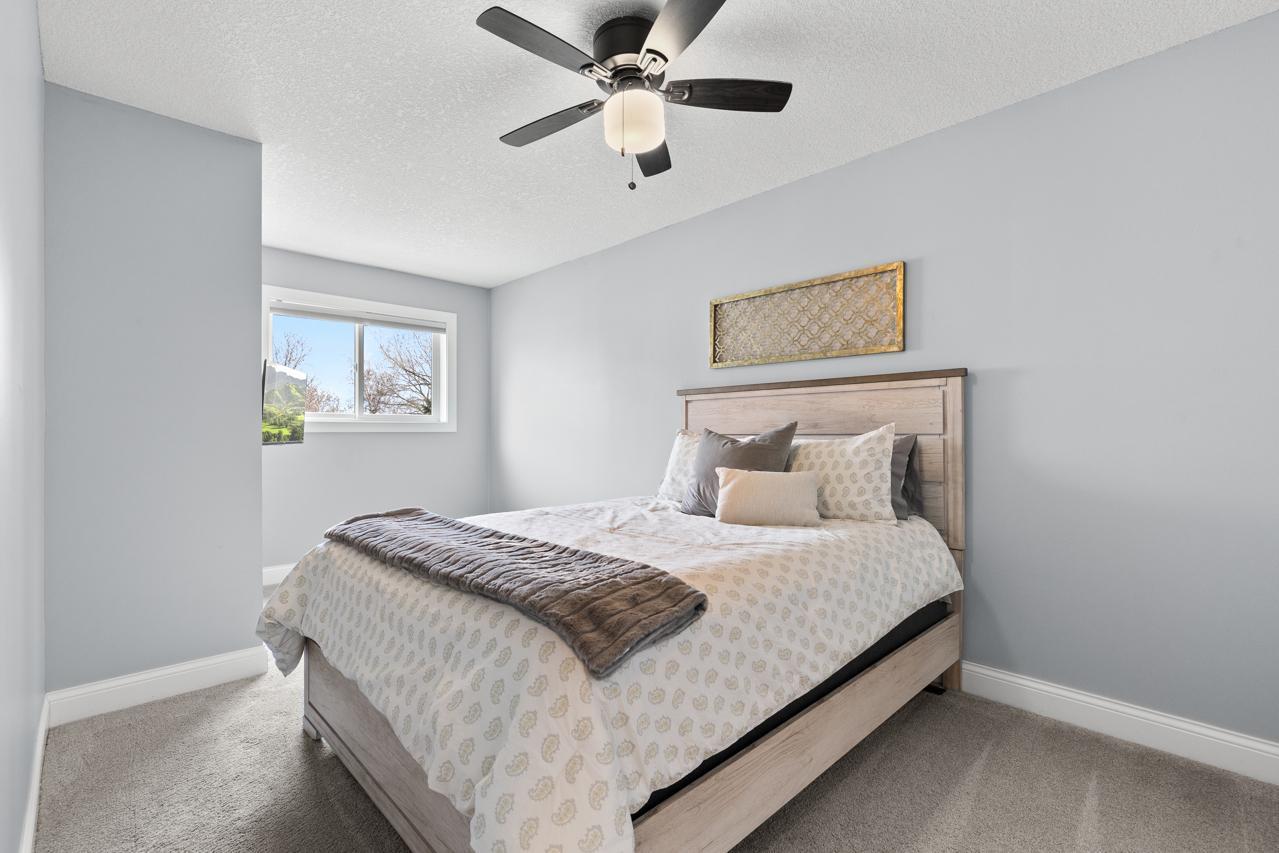 Third bedroom on the main level featuring generous room size and new carpet installed in December 2023.