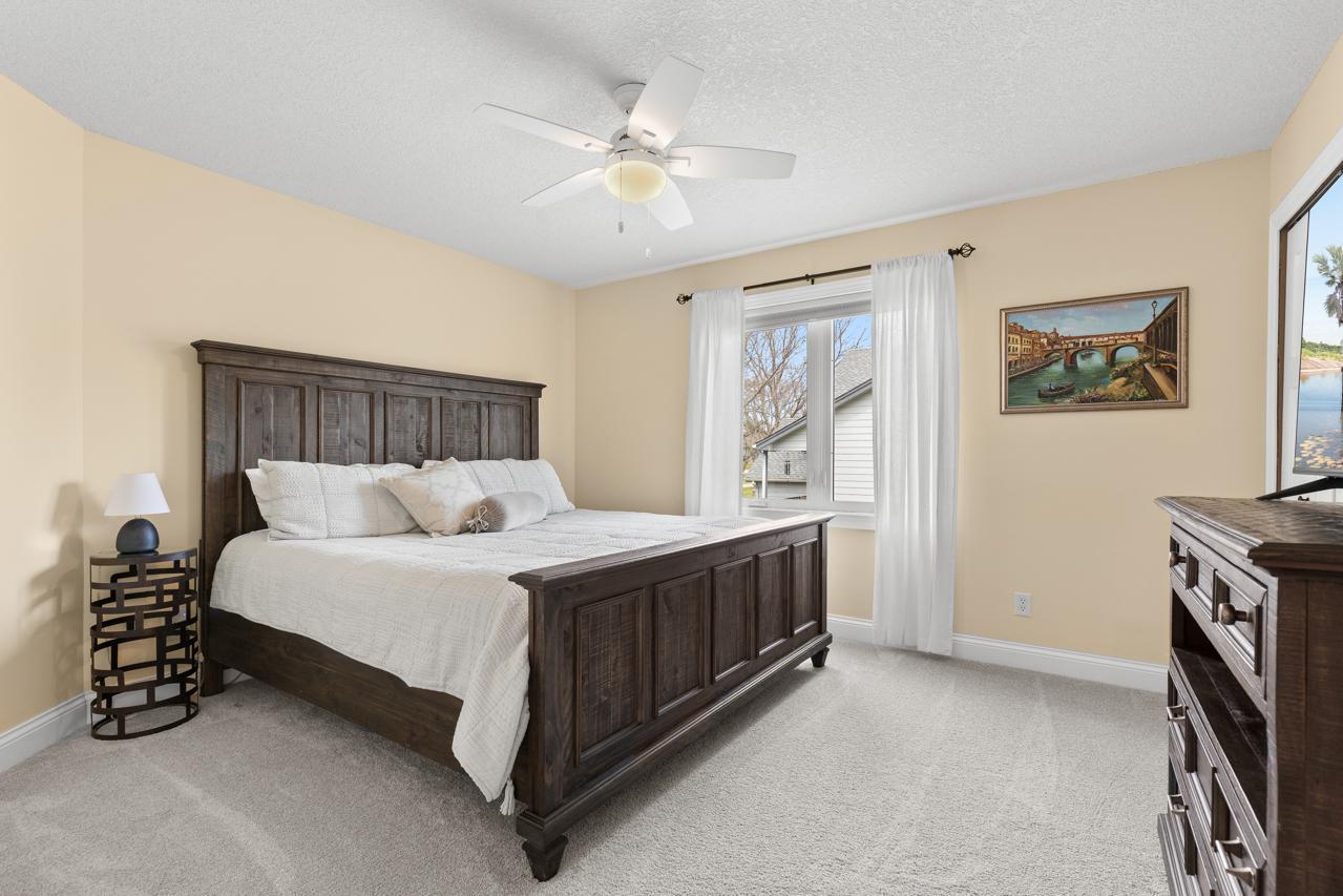 Second bedroom on the main level featuring generous room size and new carpet installed in December 2023.