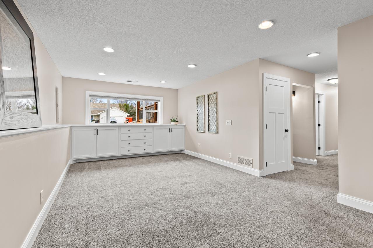 Additional lower-level living space with built-in cabinetry, ideal for a media room, play area, or flexible use.