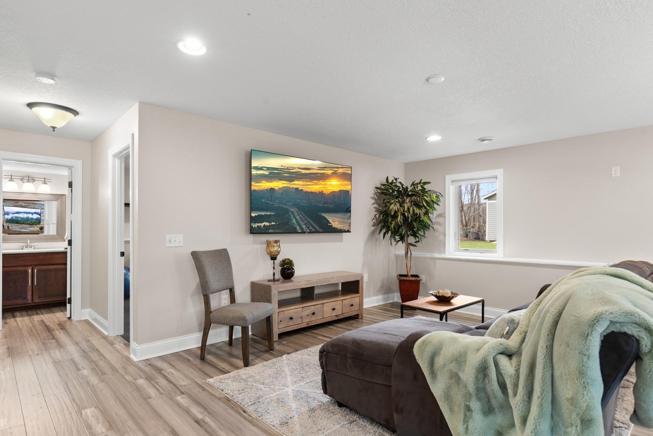 Inviting lower-level living area with a comfortable layout, ideal for relaxing or entertaining.