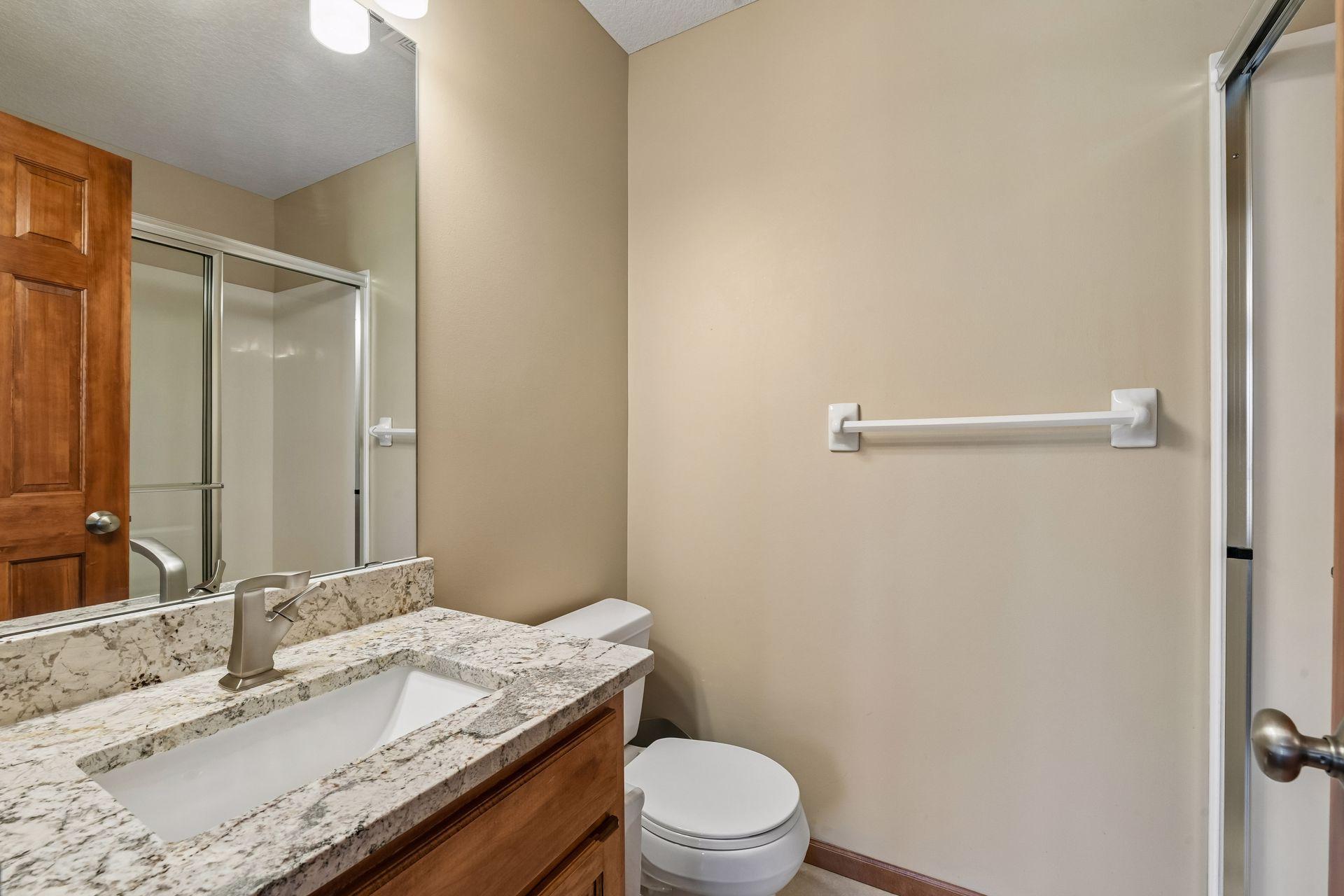 The Junior Suite 3/4 bathroom has been updated with granite countertops.