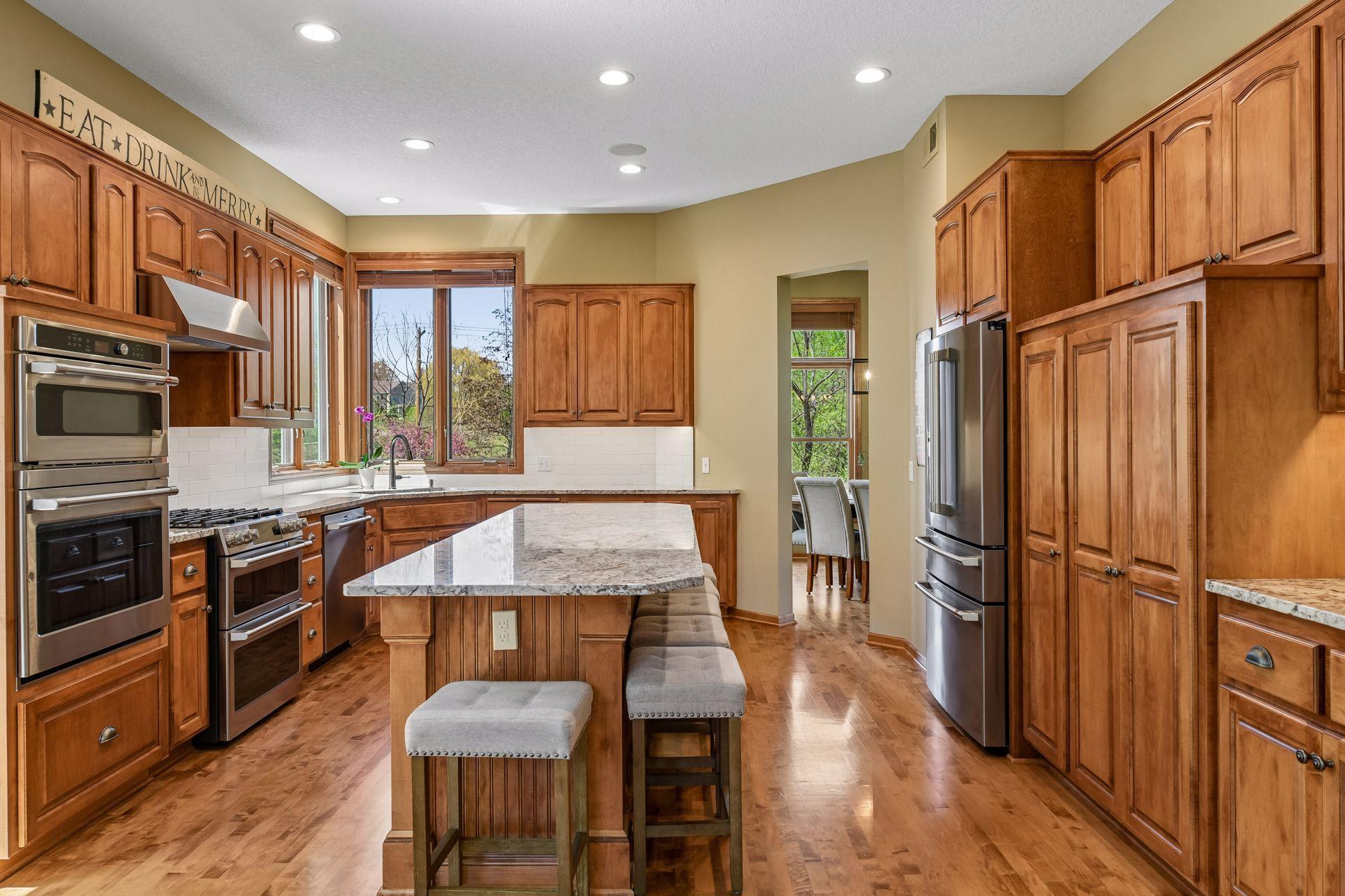 The kitchen's extensive cabinetry offers new custom roll-out shelving, undercabinet lighting and granite countertops.