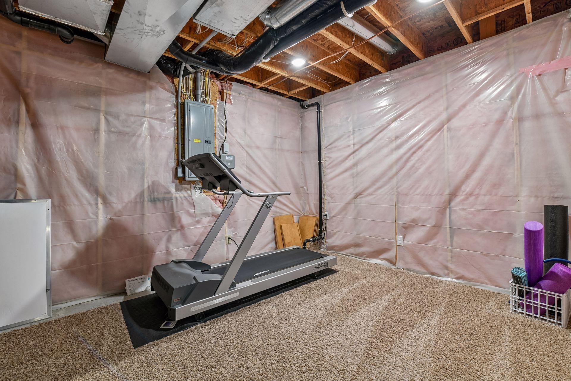 The lower level offers ample storage space with two large, unfinished storage rooms. This space is currently used as an exercise room.