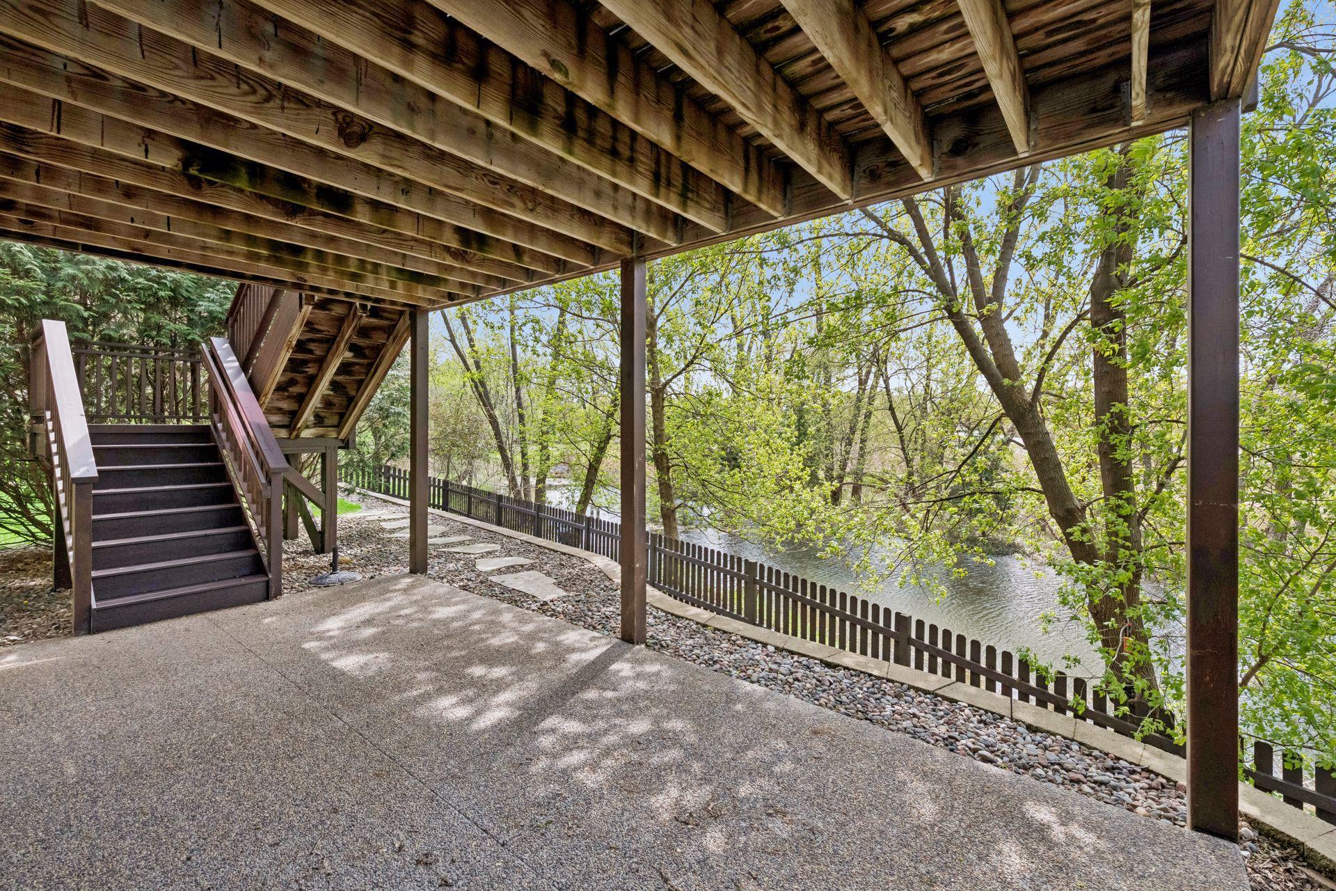 A new patio on the lower level enjoys pond views and the charming willow trees.