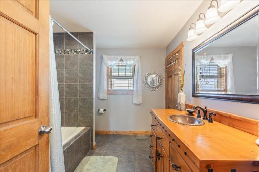 Walk through bathroom with jucuzi tub and copper sink