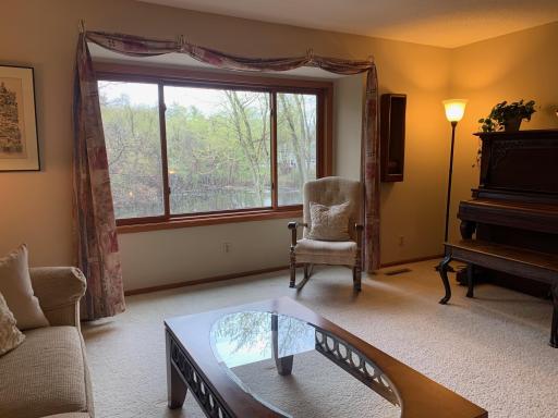 Large WIndows at Living Room frame the Beautiful Pond view