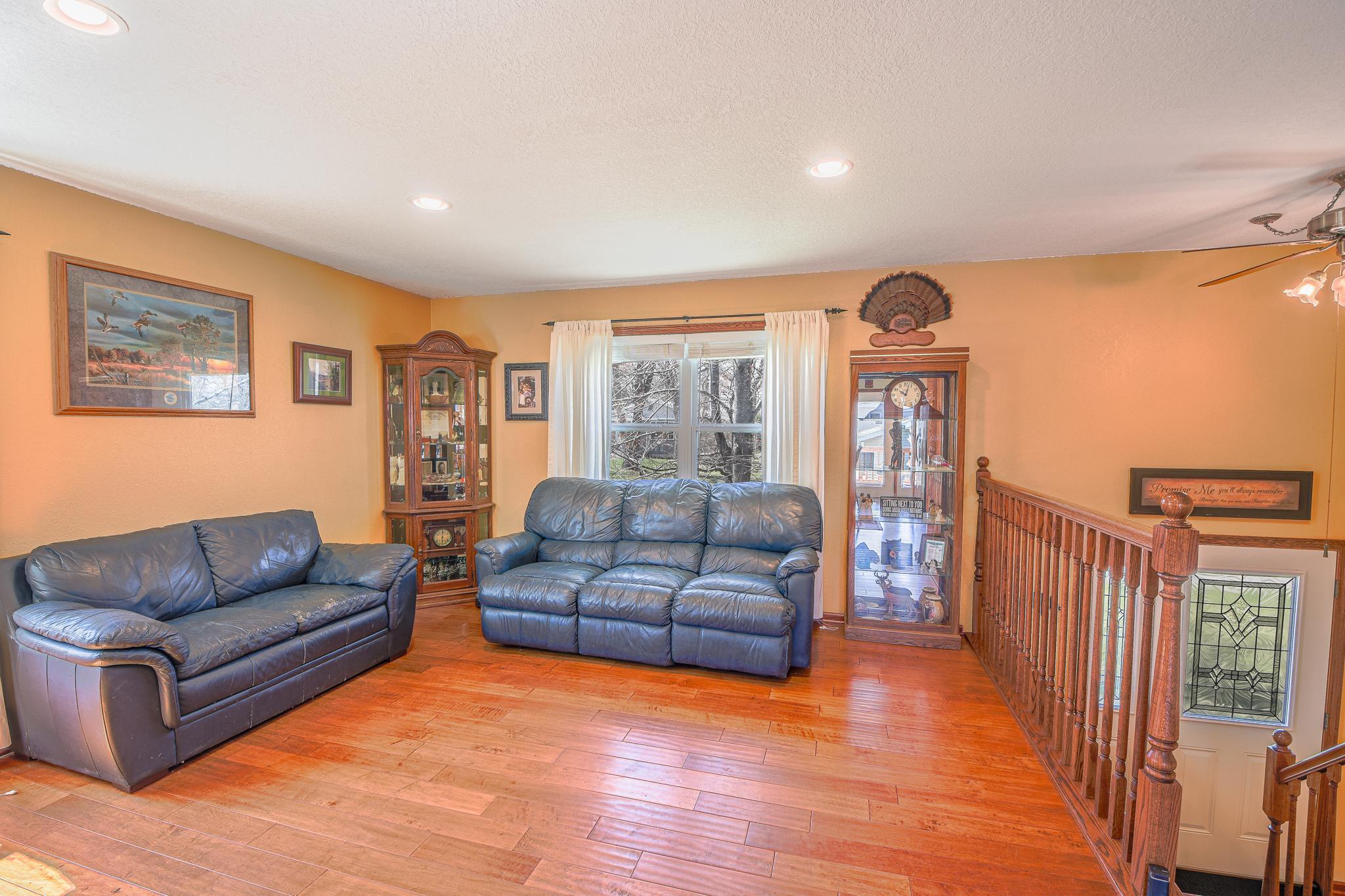 Well lit and inviting upper level living room.