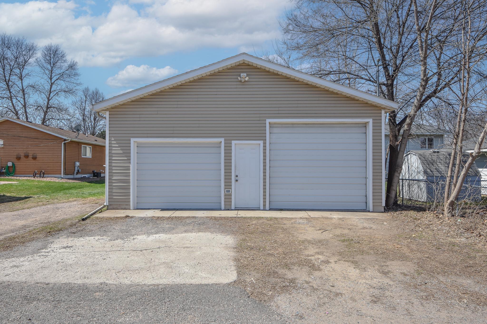 Expansive, insulated detached garage with brand new gas furnace. Features a heater and wall A/C unit.