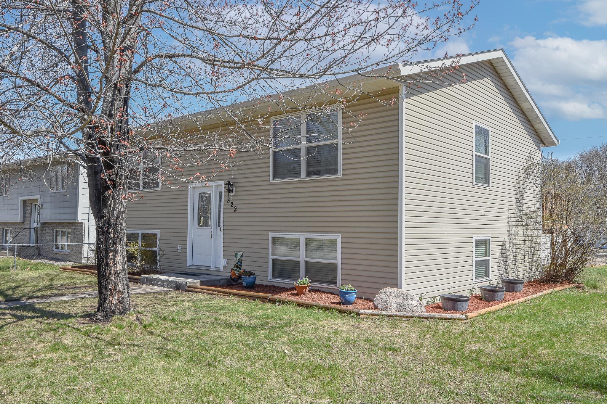 Mature tree shades the front entrance during the hot months.