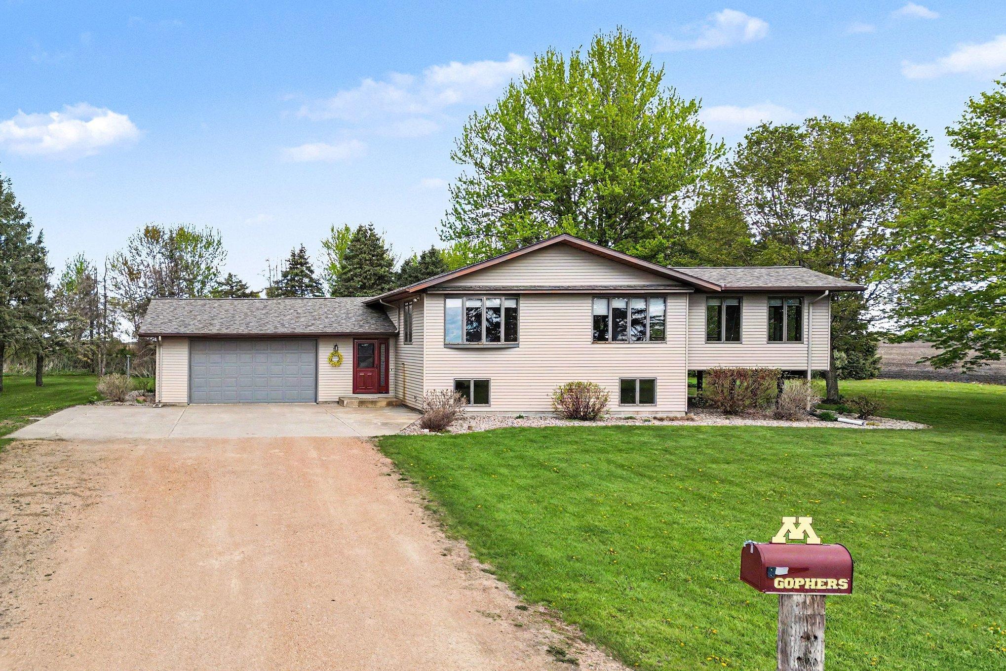 Front exterior with attached 2-car garage and brand-new roof