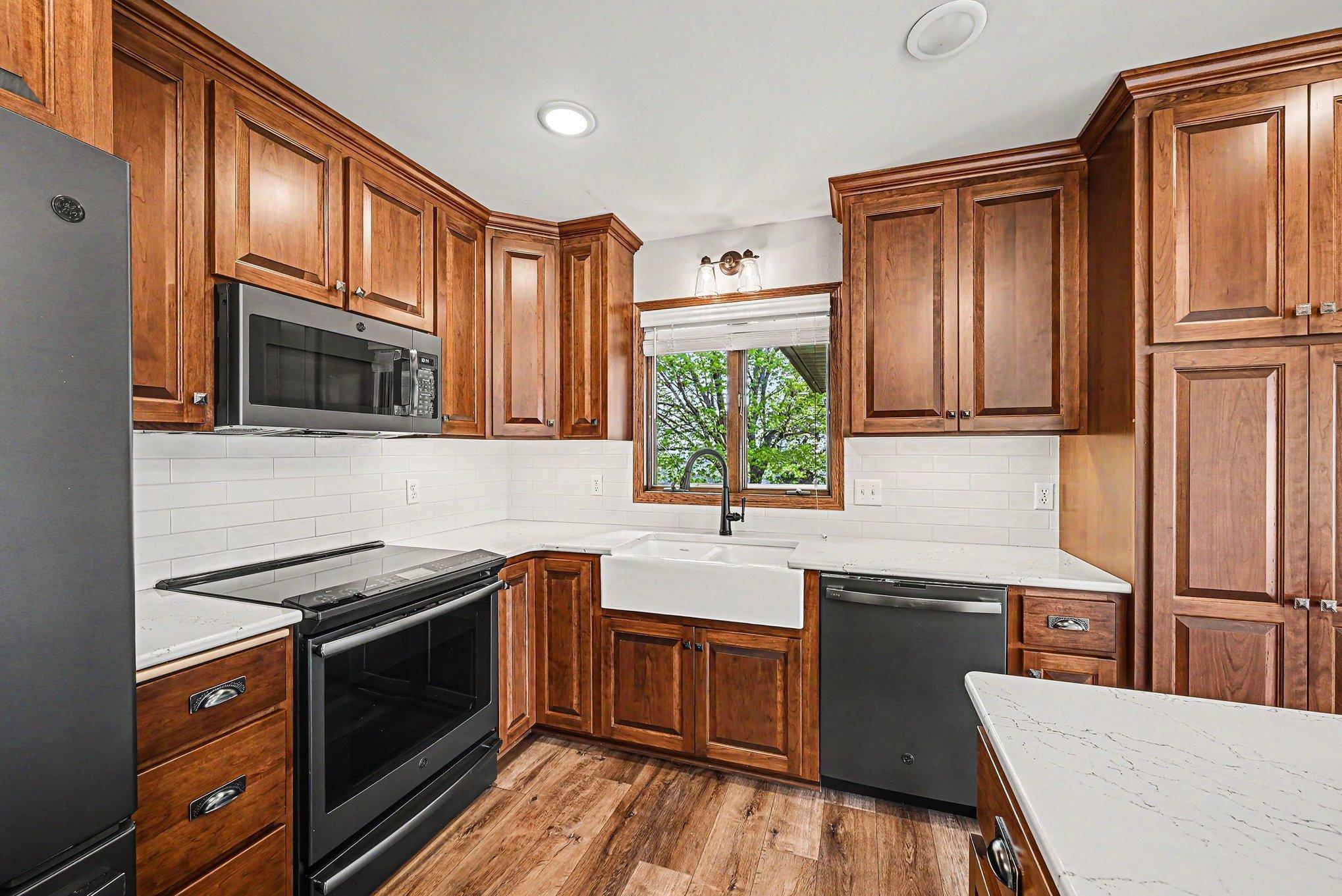 Kitchen with farmhouse sink, GE appliances, and soft-close cabinetry