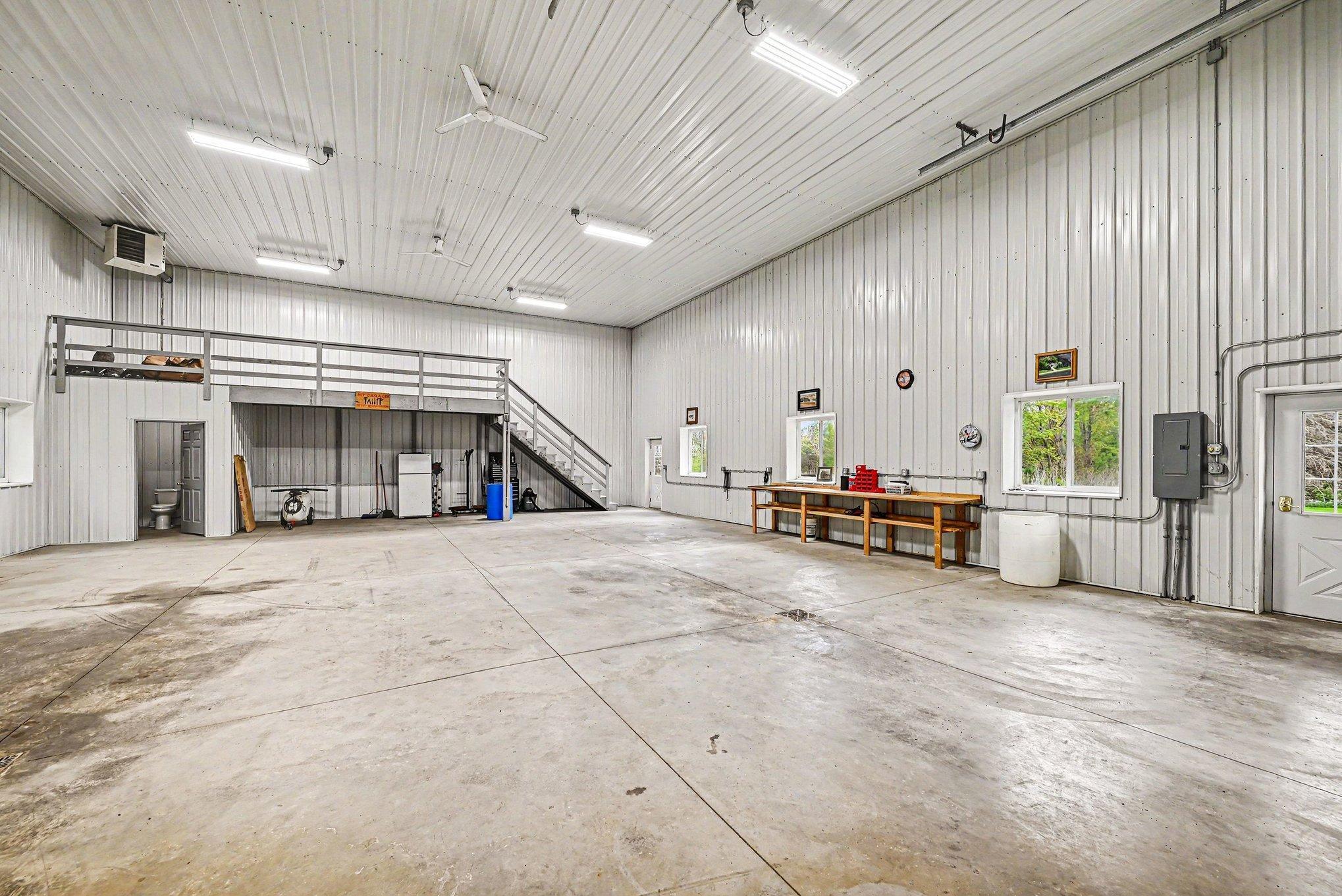Heated 52x40 shop with drains, loft, bathroom, holding tank, separate LP tank, and 14-foot door