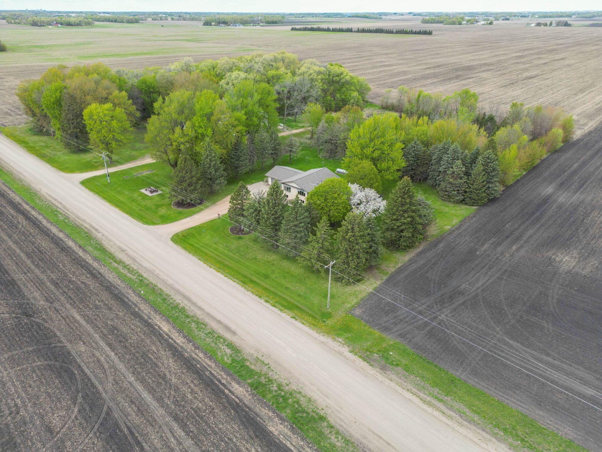 Roadside aerial view of the home and farmland