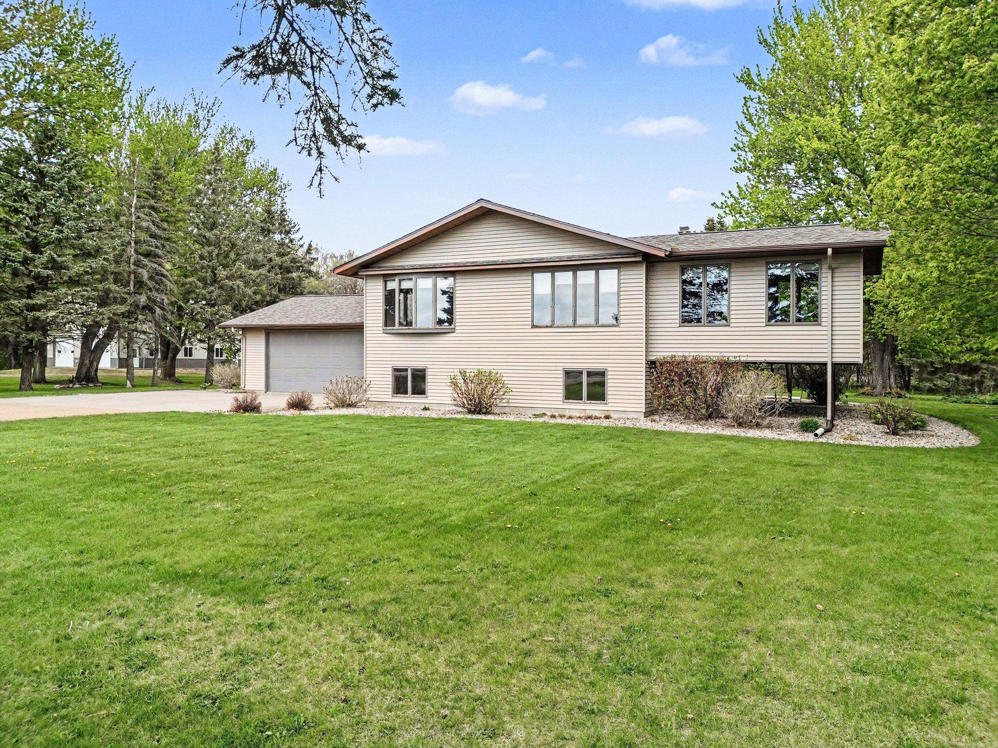 Angled front view framed by mature trees