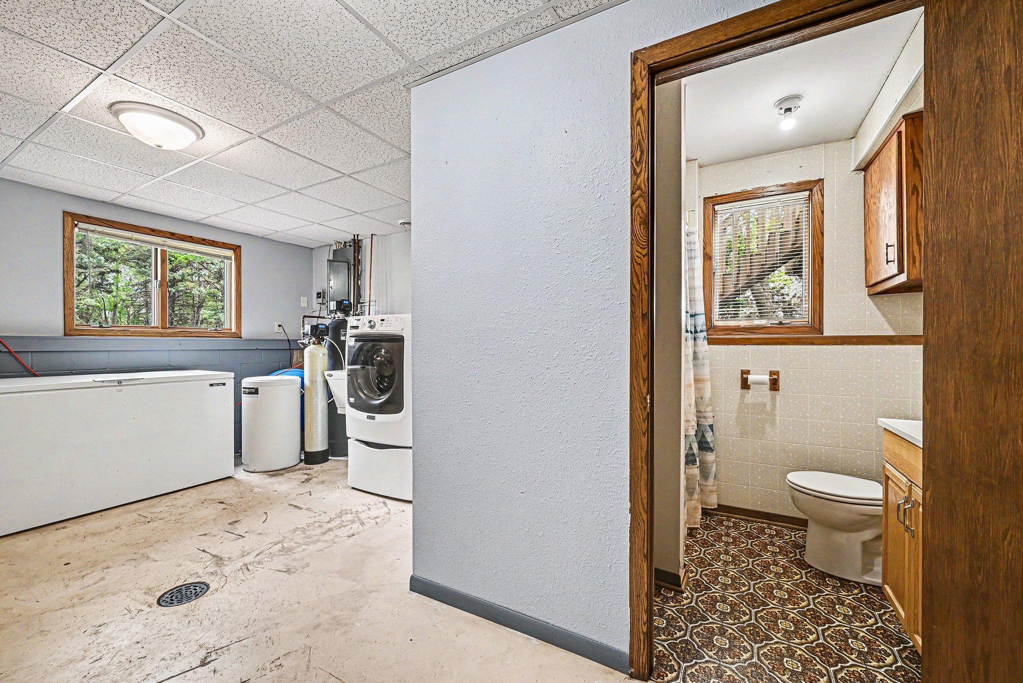 Lower-level laundry with adjacent three-quarter bath