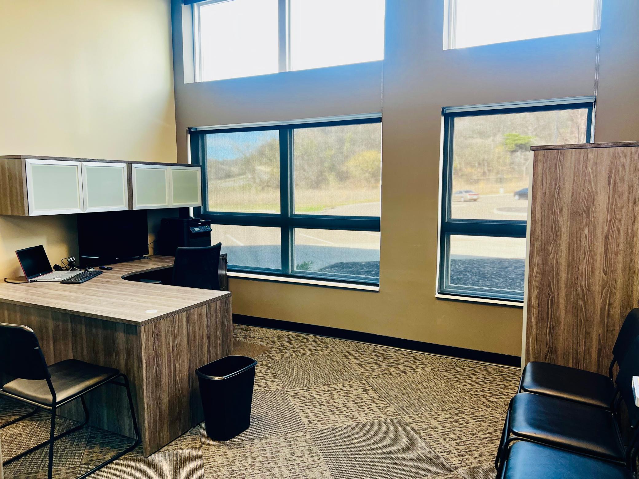 Offices feature large windows and high ceilings for an open, elevated feel.