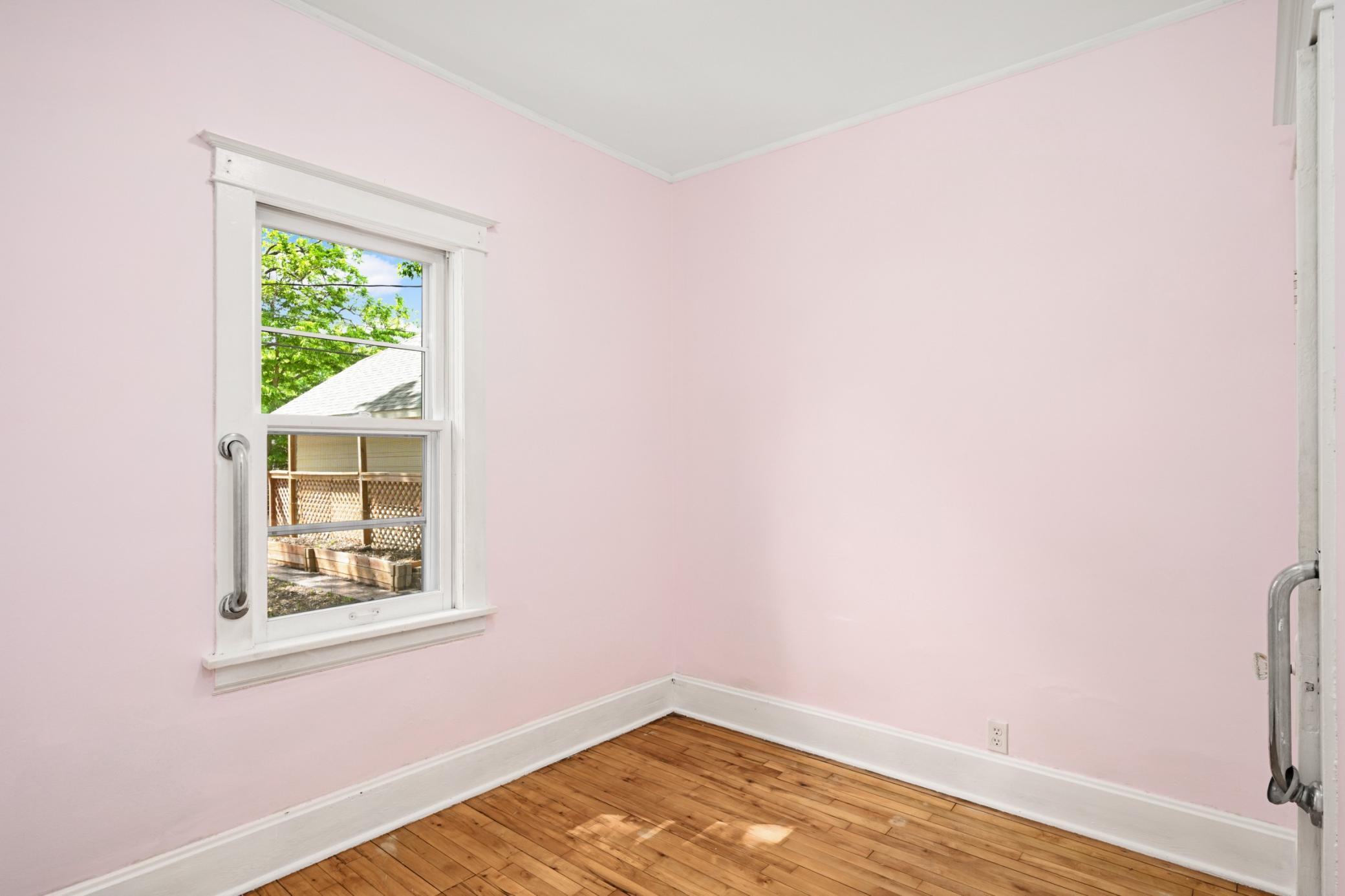 Comfortable main floor bedroom with natural light.
