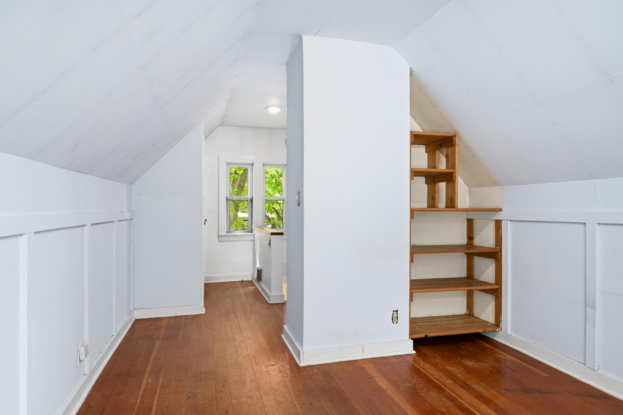 Upstairs bedroom has built in shelving.