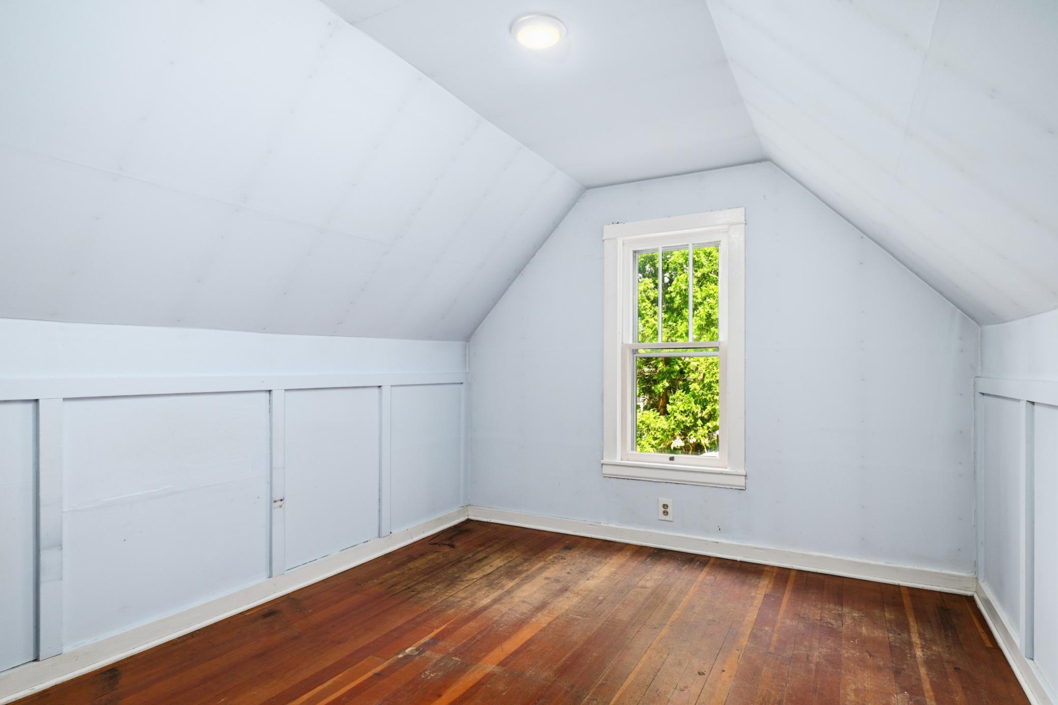 Upstairs bedroom with hardwood floors.