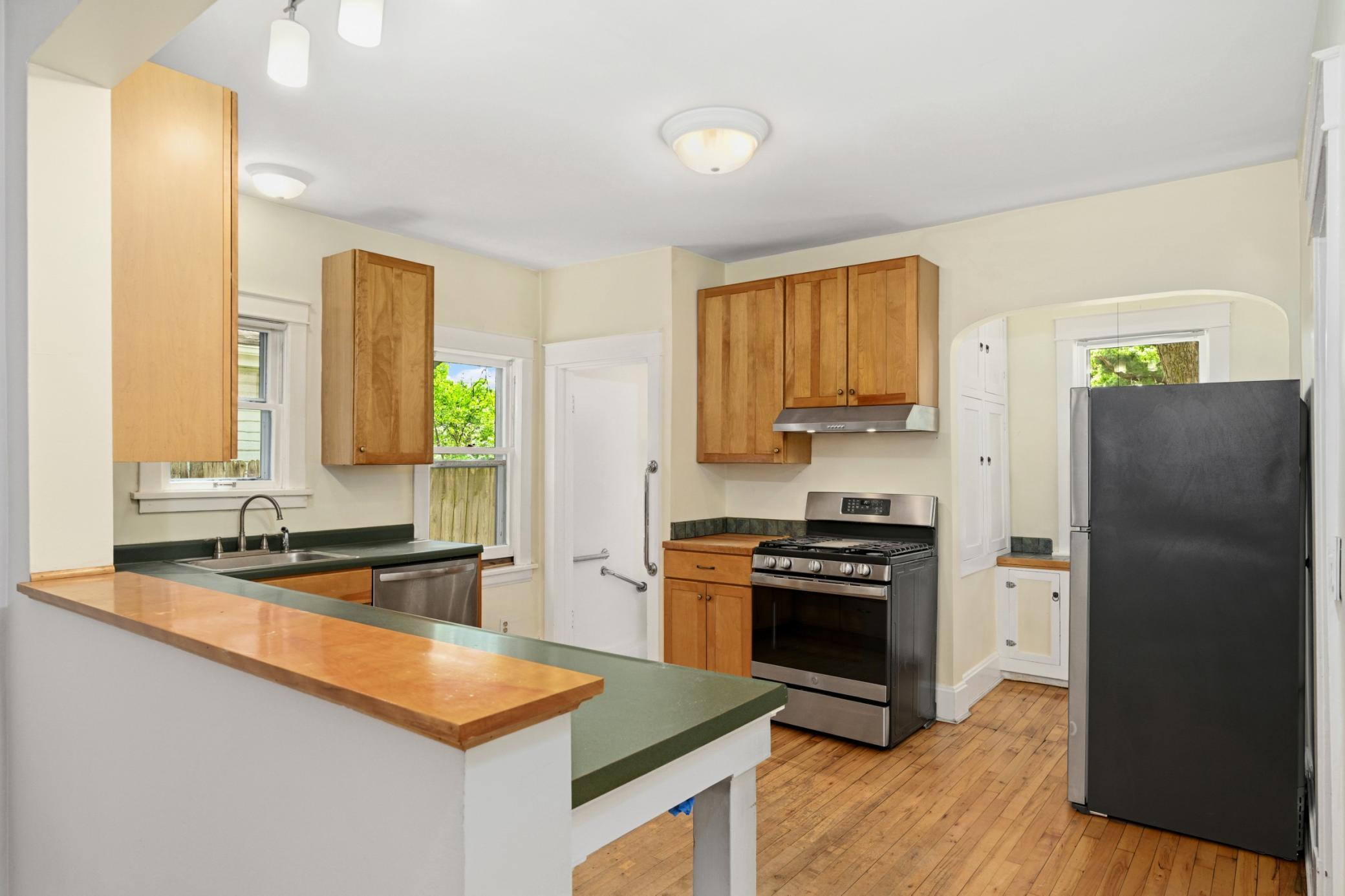 Free-flowing kitchen with abundant cabinet storage.