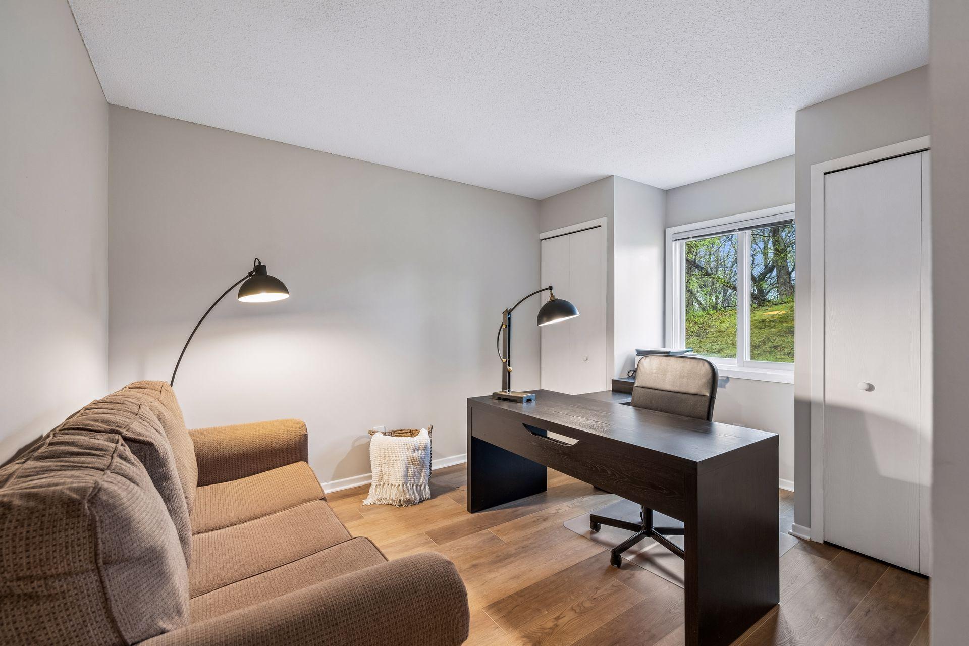 Third bedroom with two closets currently being used as an office space