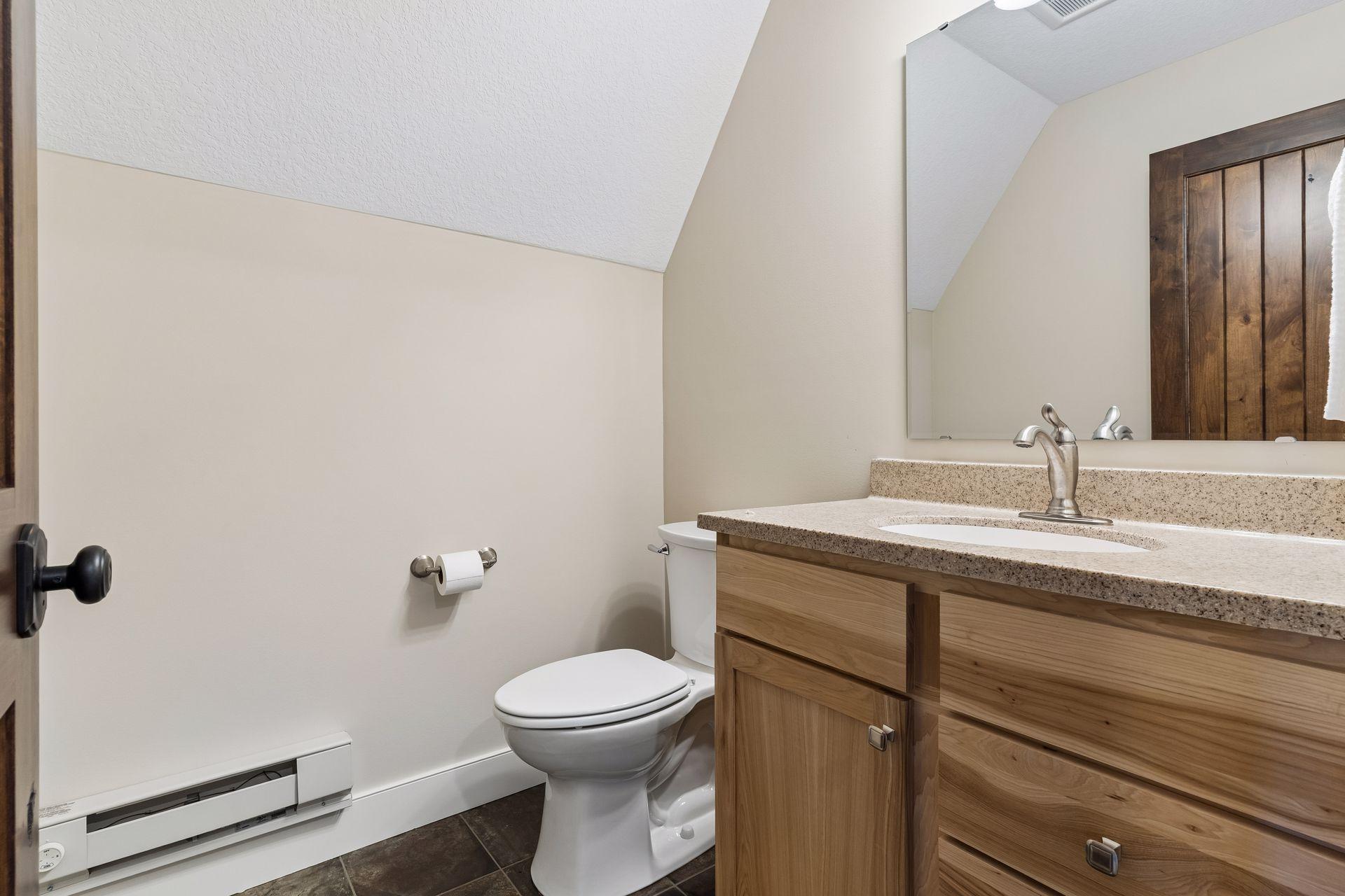 Convenient upper-level half bath serves the bonus/flex room.