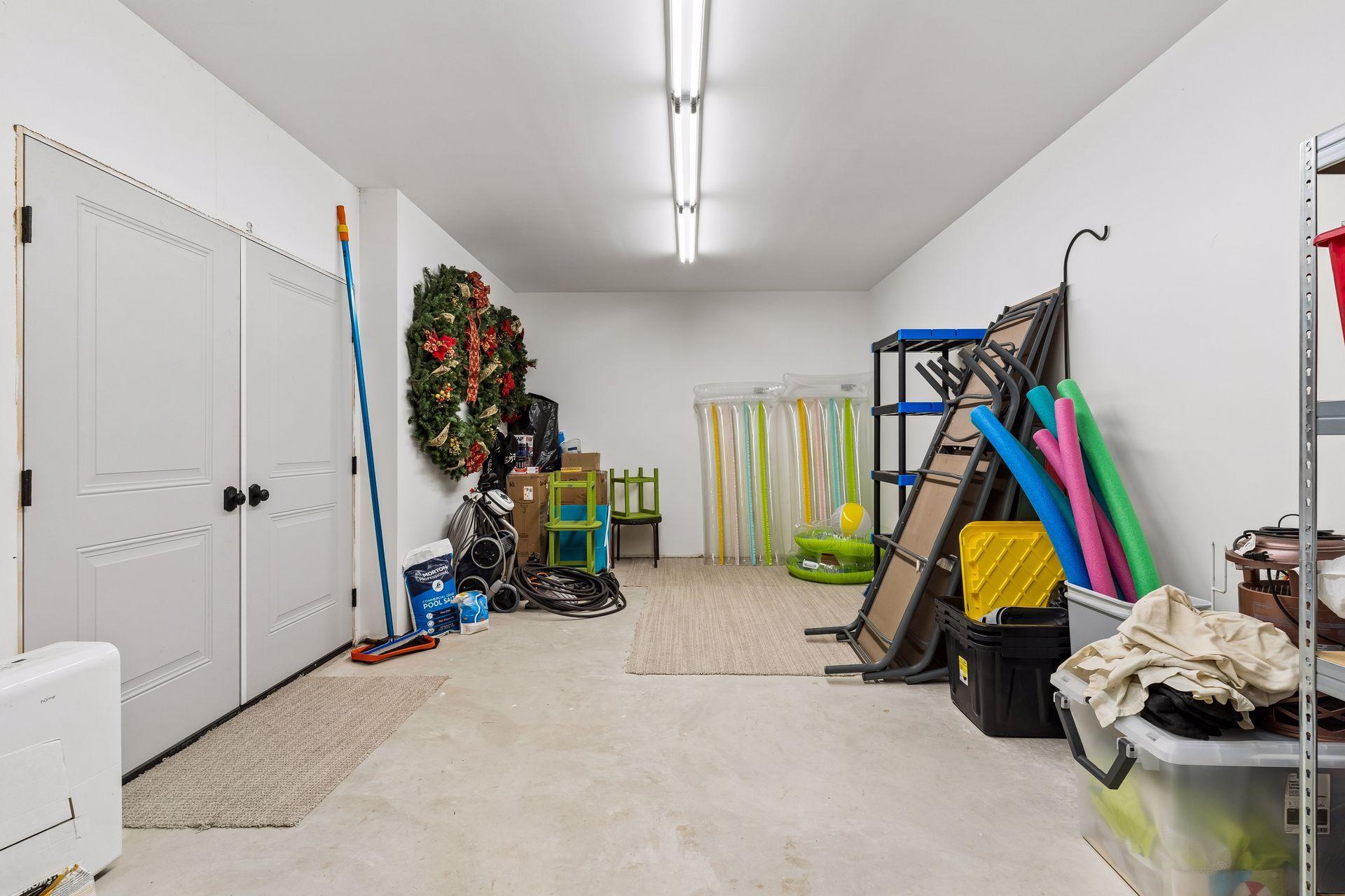 Heated pool storage under the garage provides convenient space for pool equipment, patio furniture, seasonal items, and outdoor essentials.