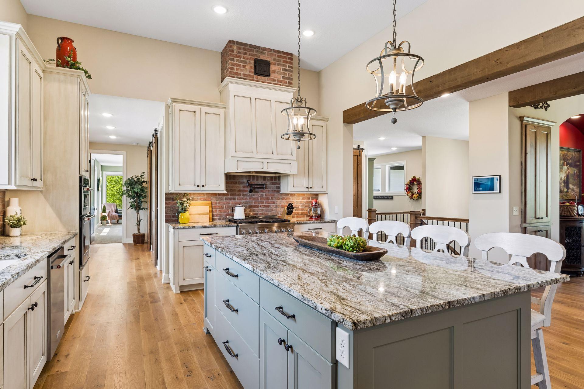 A beautiful granite center island anchors the kitchen, offering generous prep space, seating, and a seamless connection to the surrounding living and dining areas.