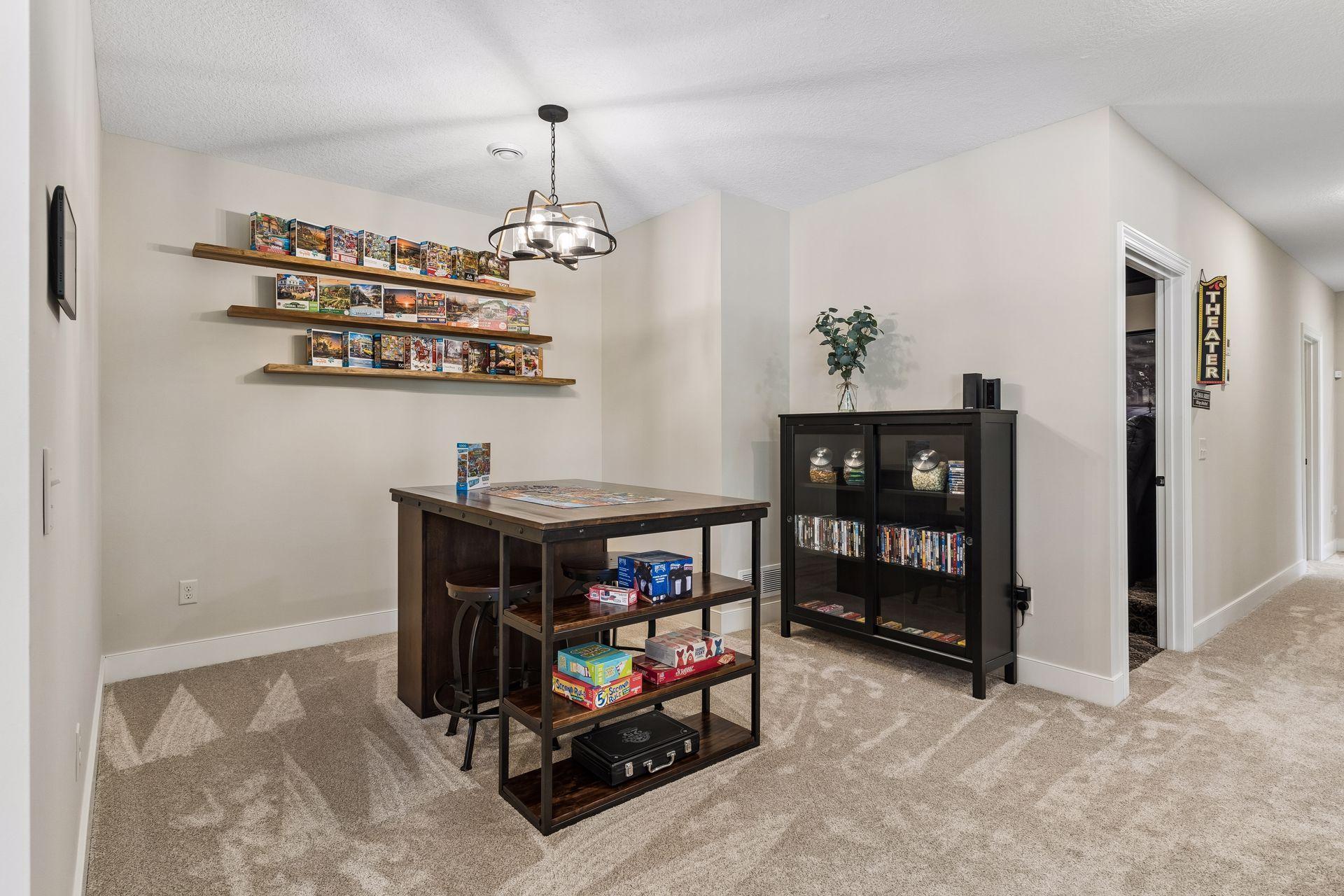 The spacious game room offers plenty of room for recreation, gathering, and entertaining, with direct flow between the kitchenette, family room, and pool area.