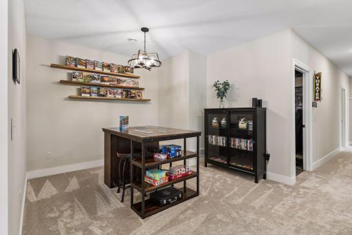 The spacious game room offers plenty of room for recreation, gathering, and entertaining, with direct flow between the kitchenette, family room, and pool area.