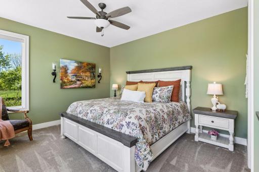 A comfortable main-floor ensuite bedroom offers privacy for guests or family, with generous natural light, soft finishes, and convenient access to its own private bath.
