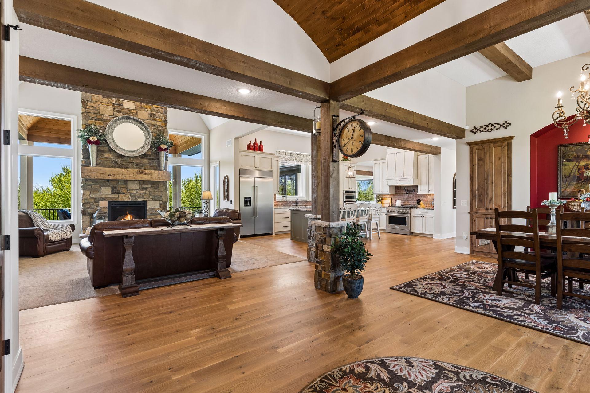 Step inside to a grand first impression, where warm wood beams and hardwood floors welcome you into an elegant open-concept design created for luxury living.