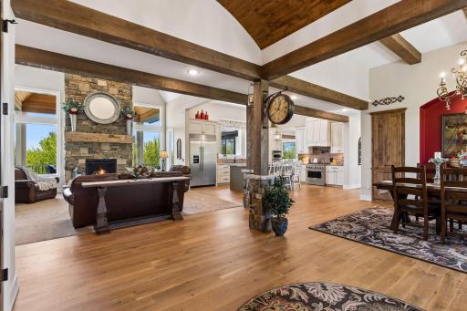 Step inside to a grand first impression, where warm wood beams and hardwood floors welcome you into an elegant open-concept design created for luxury living.