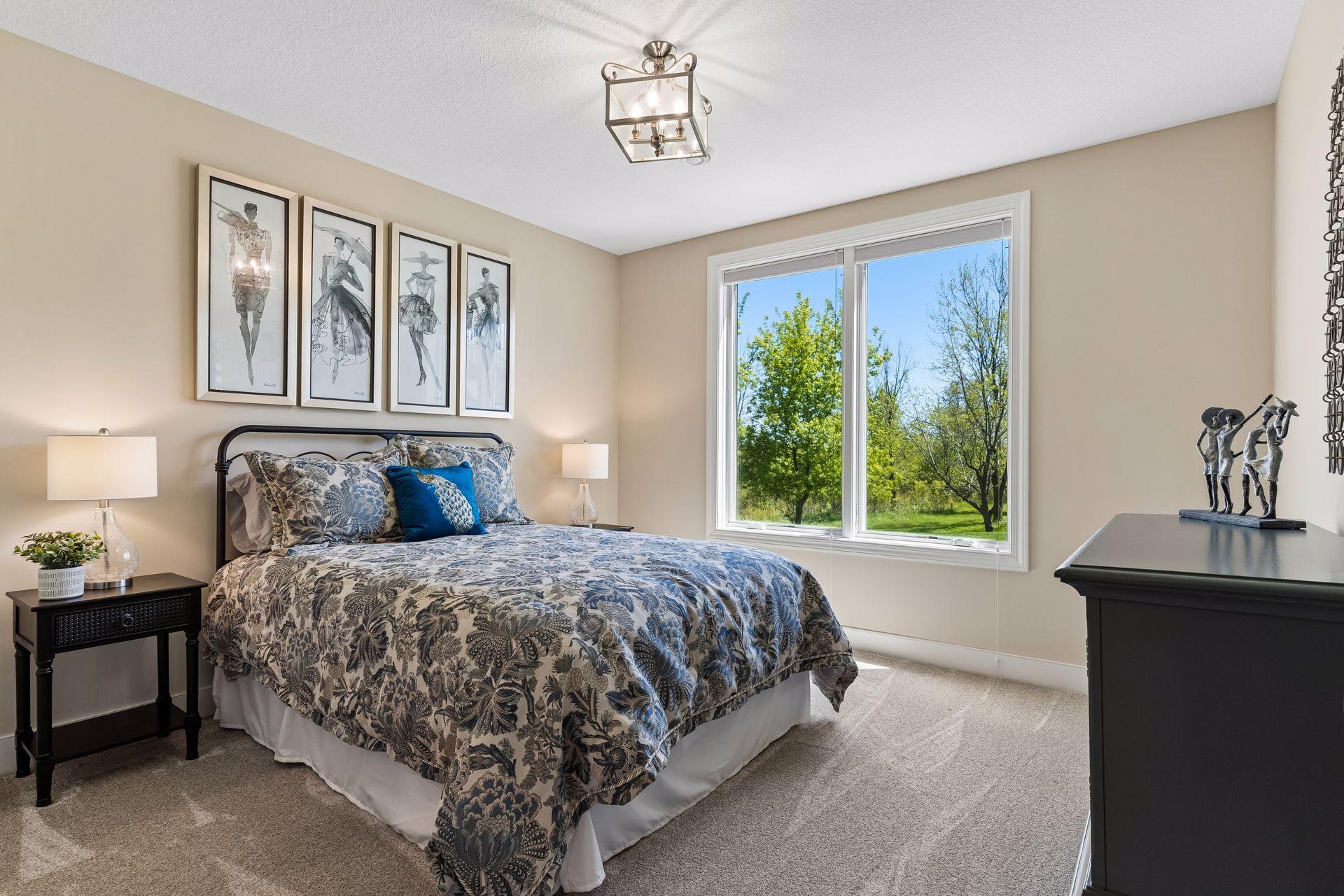 One of two lower-level bedrooms, this comfortable guest room offers natural light, generous space, and convenient access to the nearby full bath.