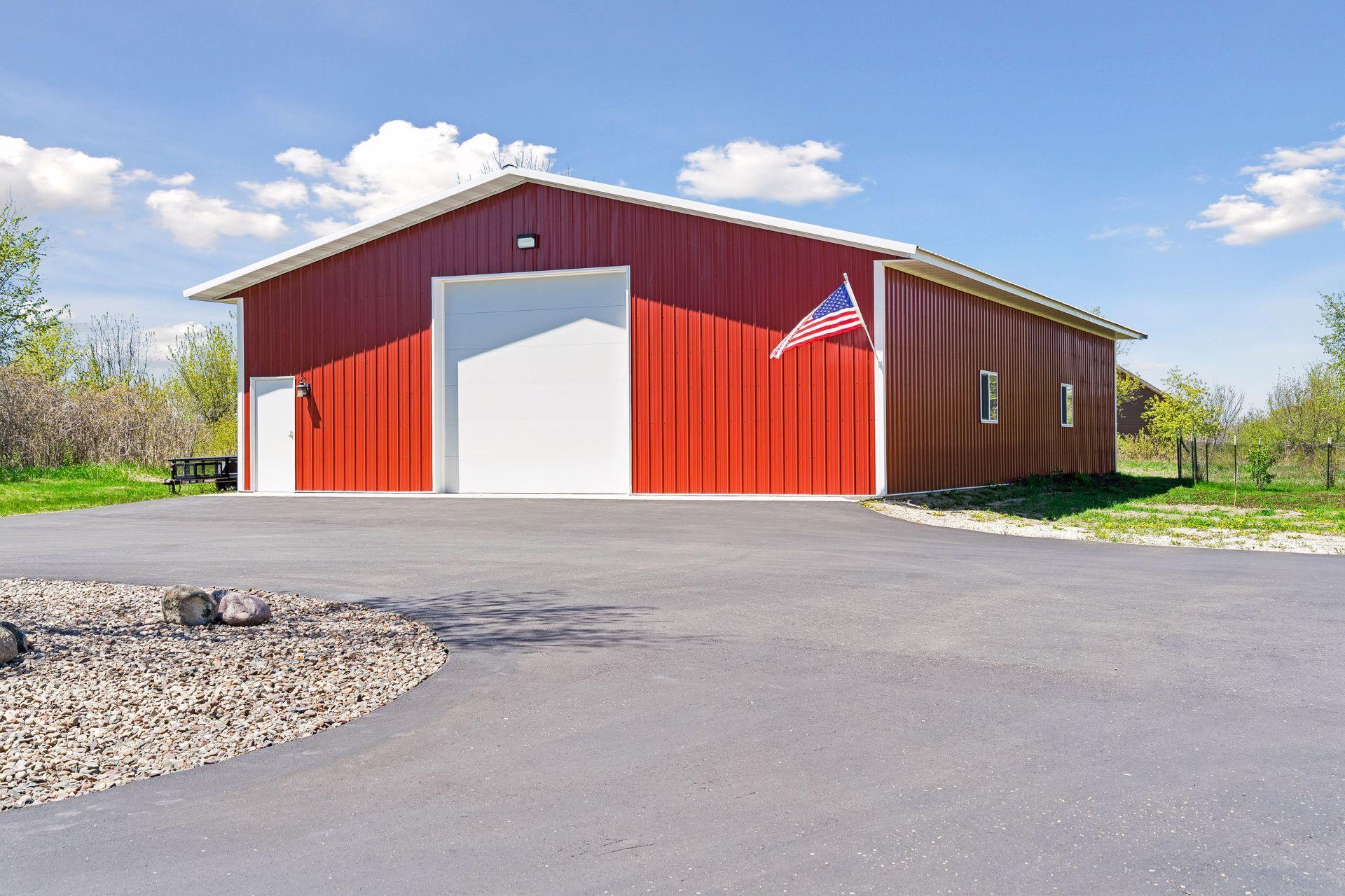The 64x40 heated and insulated outbuilding offers exceptional flexibility with a 12-foot RV-height overhead door, separate gas meter, hardwired internet capability, and interior water access.