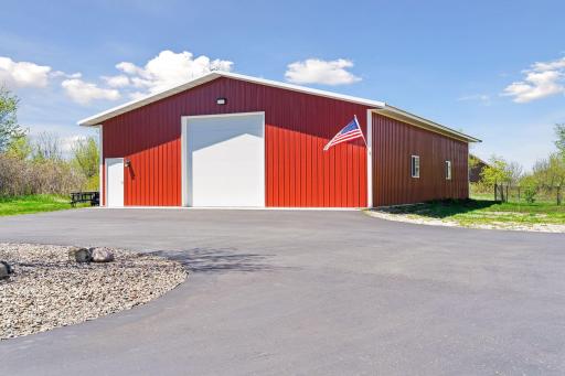 The 64x40 heated and insulated outbuilding offers exceptional flexibility with a 12-foot RV-height overhead door, separate gas meter, hardwired internet capability, and interior water access.