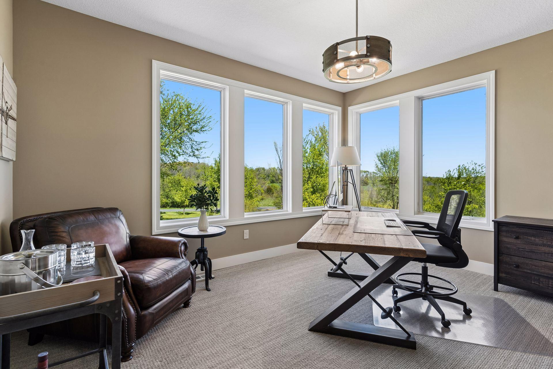 The main-floor executive office offers a quiet, private workspace with expansive windows overlooking the north and east sides of the property—an ideal setting for watching deer and wildlife.