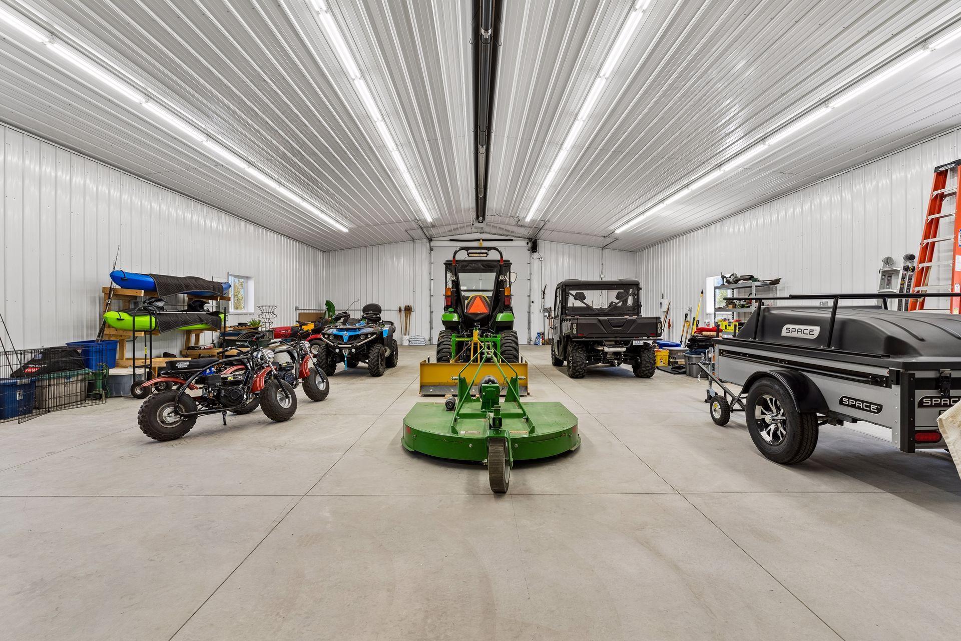 Inside, the outbuilding features radiant heat, insulated concrete floors, floor drain, LED lighting, and workbench space—ideal for business use, storage, hobbies, equipment, or recreational vehicles.