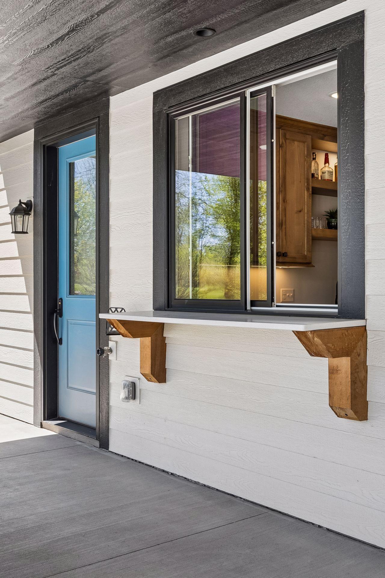 Custom alder cabinetry, open shelving, granite countertops, sink, and full-size appliances make the lower-level kitchenette ideal for hosting guests, pool days, or extended stays.
