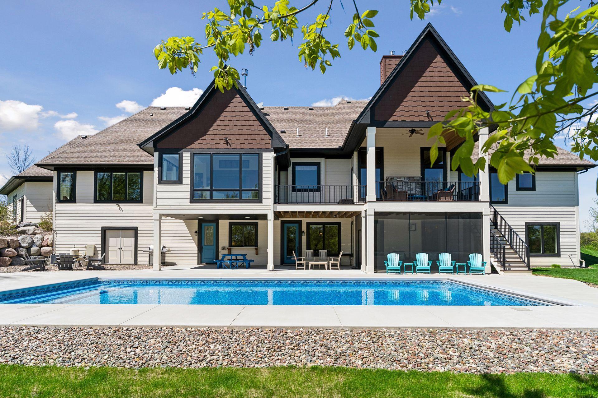 The resort-style saltwater pool creates a private backyard retreat, with generous patio space, multiple outdoor living areas, and seamless access to the home’s walkout lower level and covered deck.