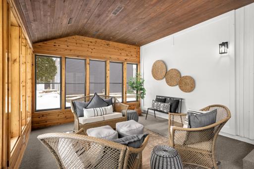 Beautiful 3 season porch with 3 sides of glass with screens looking on to the park.