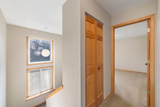 Hallway at top of stairs going into primary bedroom