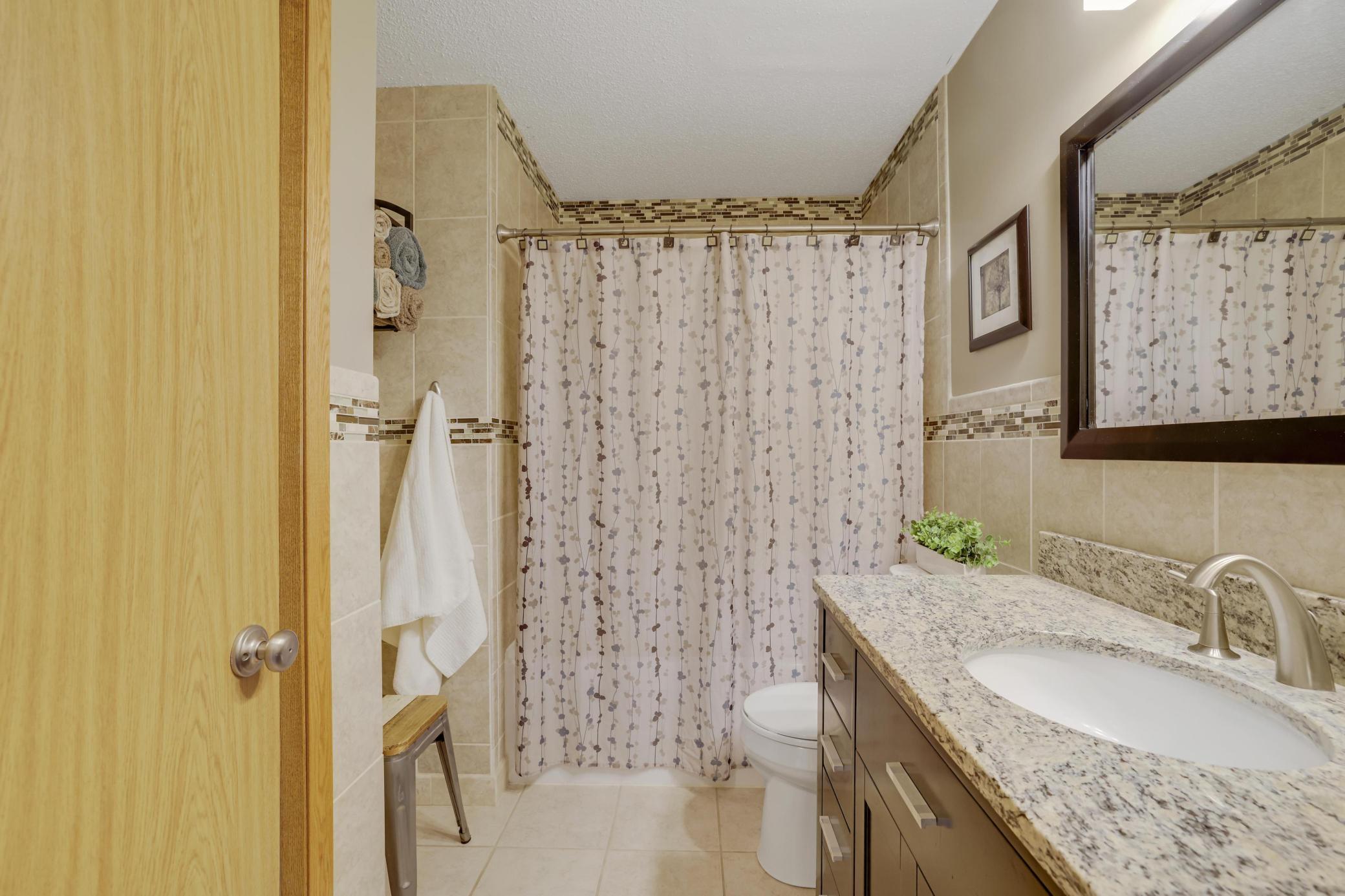 Upper level bathroom with heated tiled floors.