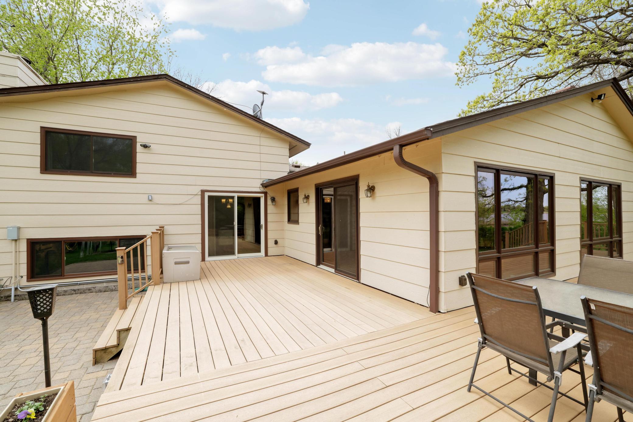 Large wrap around composite deck that steps down onto the paver patio.