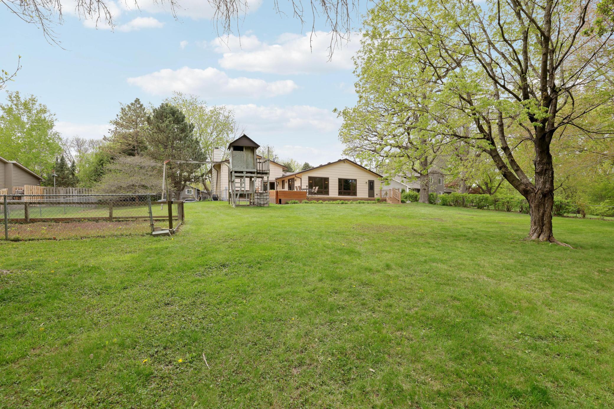 Expansive backyard with garden bed and lots of flat yard space.